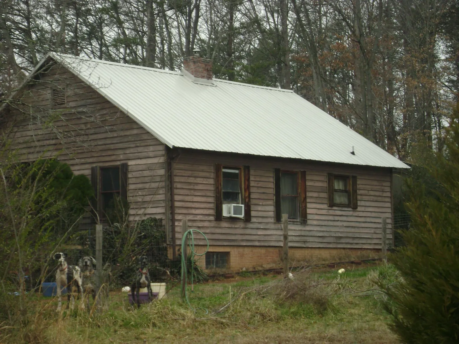 White metal roof on an old wood sided farmhouse, from a Metal Roof Installation job in Bunkerville
